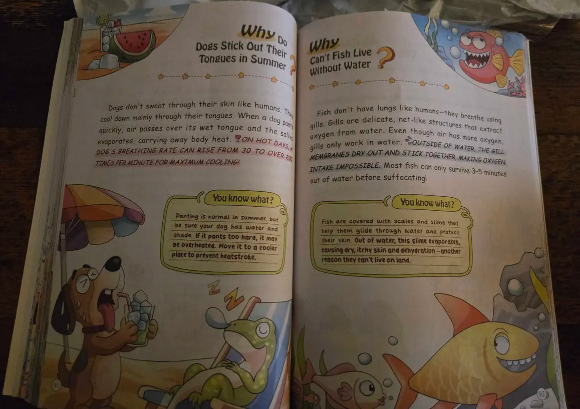 An open children's educational book spread on a dark wooden surface, showing two pages with text and cartoon illustrations about fish and water.